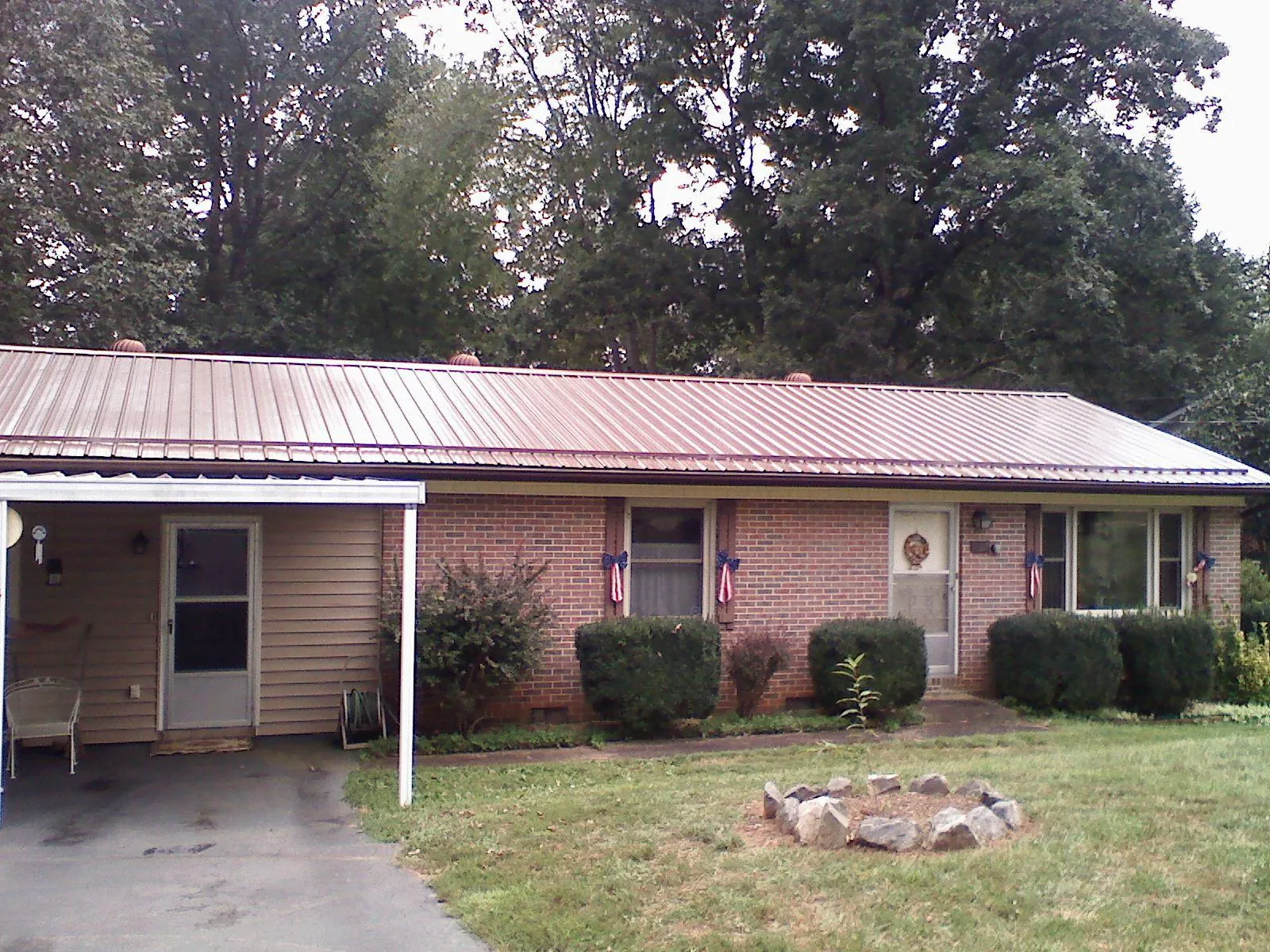 Bronze metal roof and carport on a brick ranch home — Roof Repair work by our crew in Newington