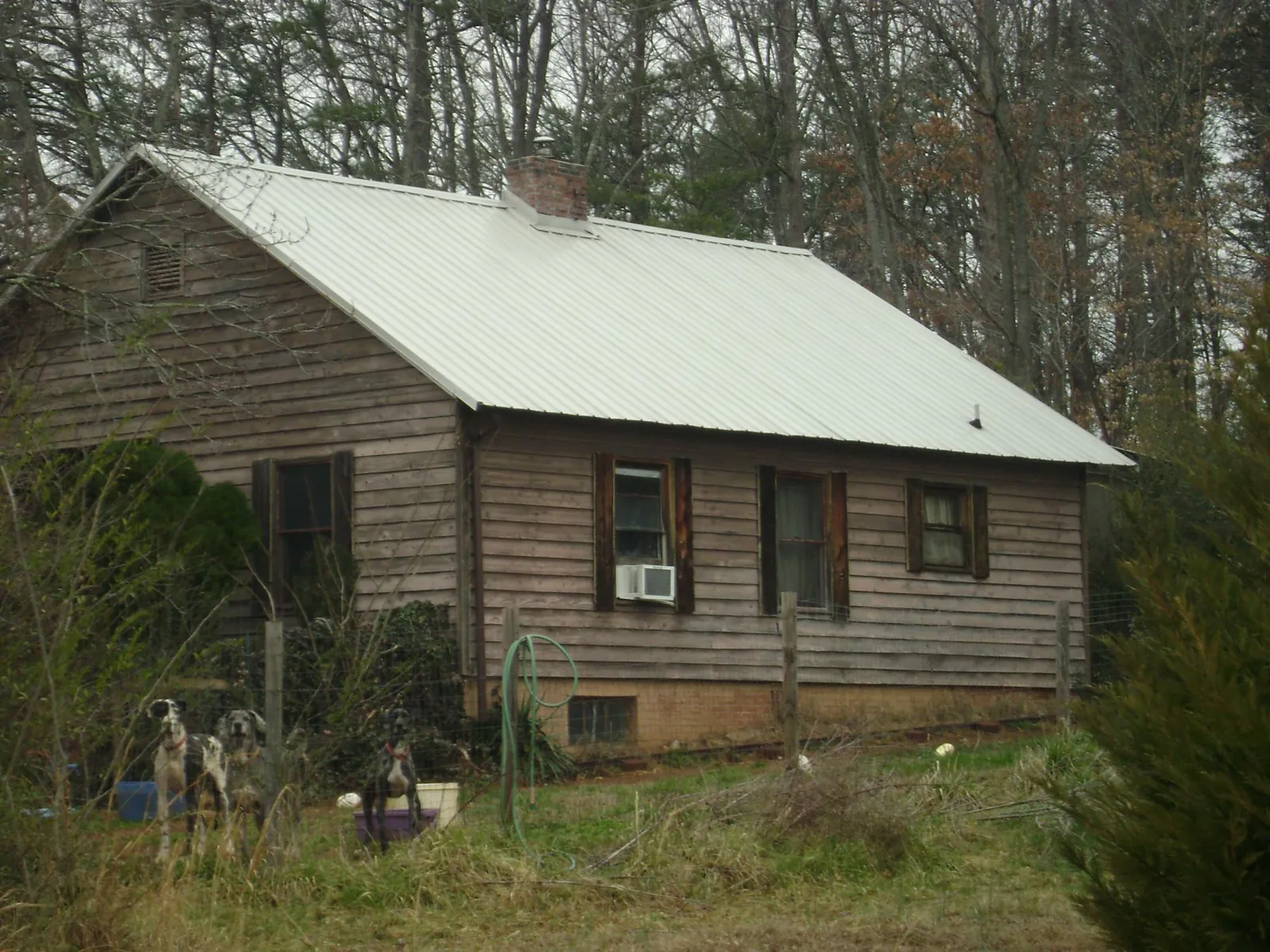 White metal roof on an old wood sided farmhouse, from a Metal Roof Installation job in Newington